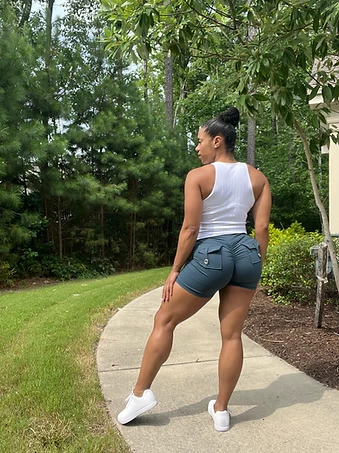 Physique coach LaToya Loren Price walking, built lower body and upright carriage