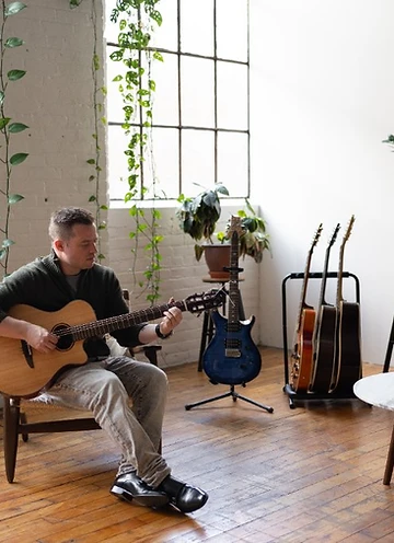 Tim Collins with a selection of his guitars