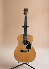 Tim's acoustic guitar against a warm backdrop