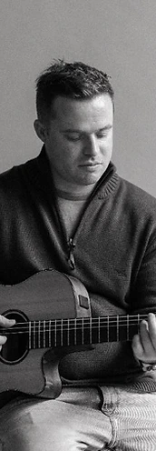 Tim playing guitar, black and white portrait