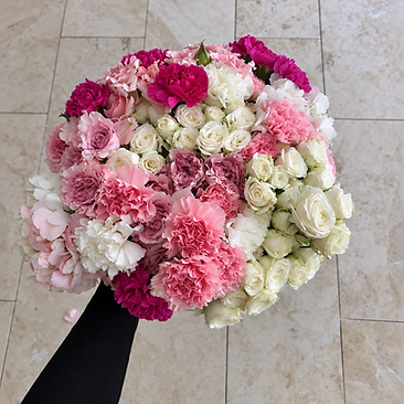 Rounded bouquet of pink and white roses, carnations and fillers