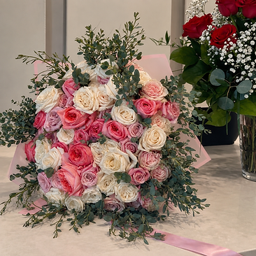 Large mixed bouquet of pink and cream roses with eucalyptus foliage