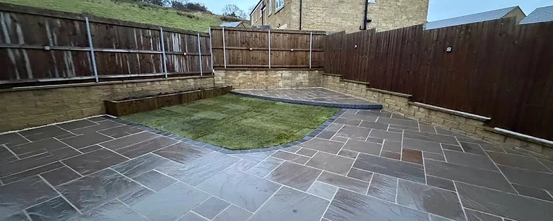 Two-tier slate patio and turf project by JMB in Colne