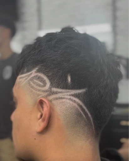 El Navajón haircut — shaved design, hair tattoo
