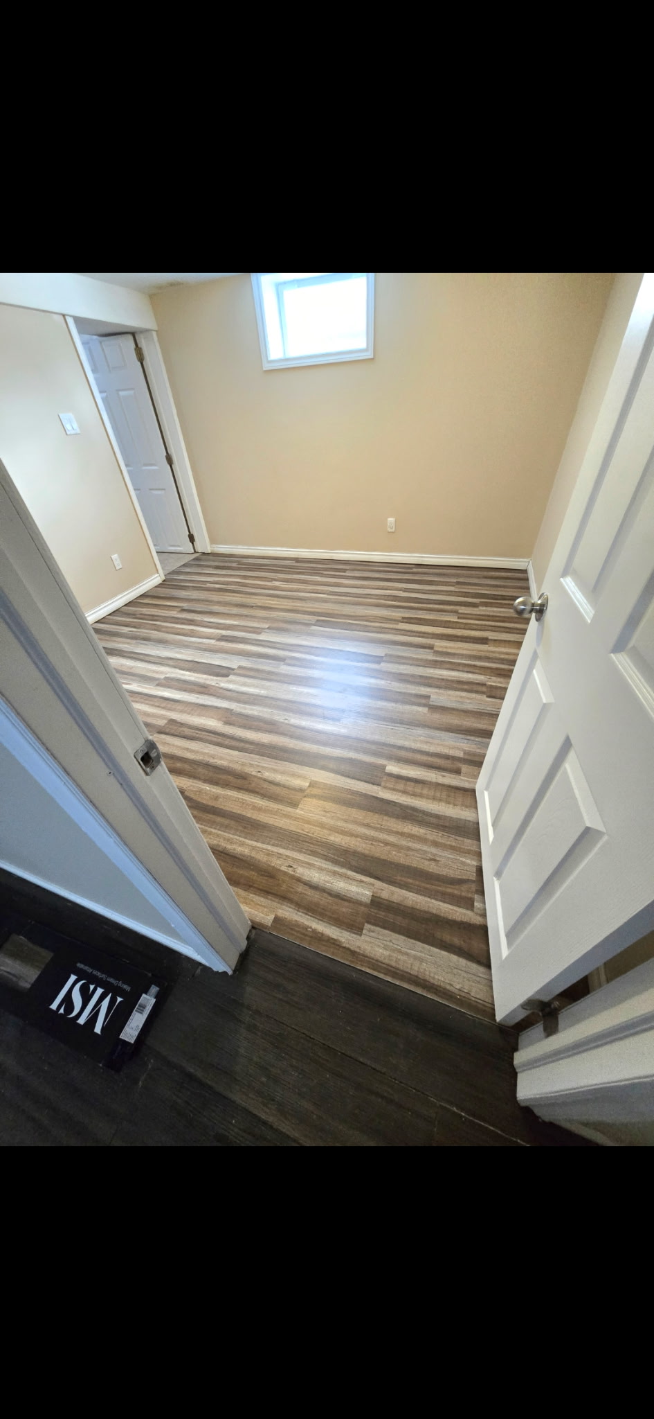 Finished basement renovation with new luxury vinyl plank flooring