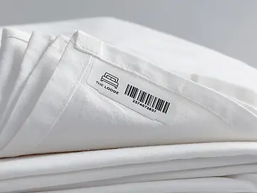 Barcode tracking label on folded linen