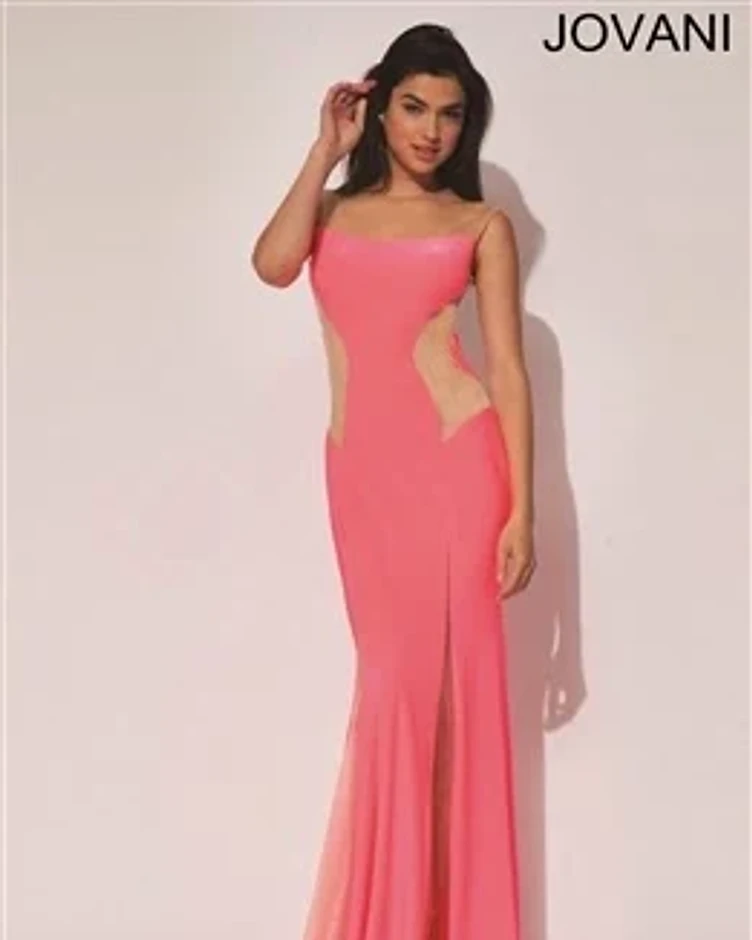 Model wearing a coral-pink formal gown with cut-out detailing