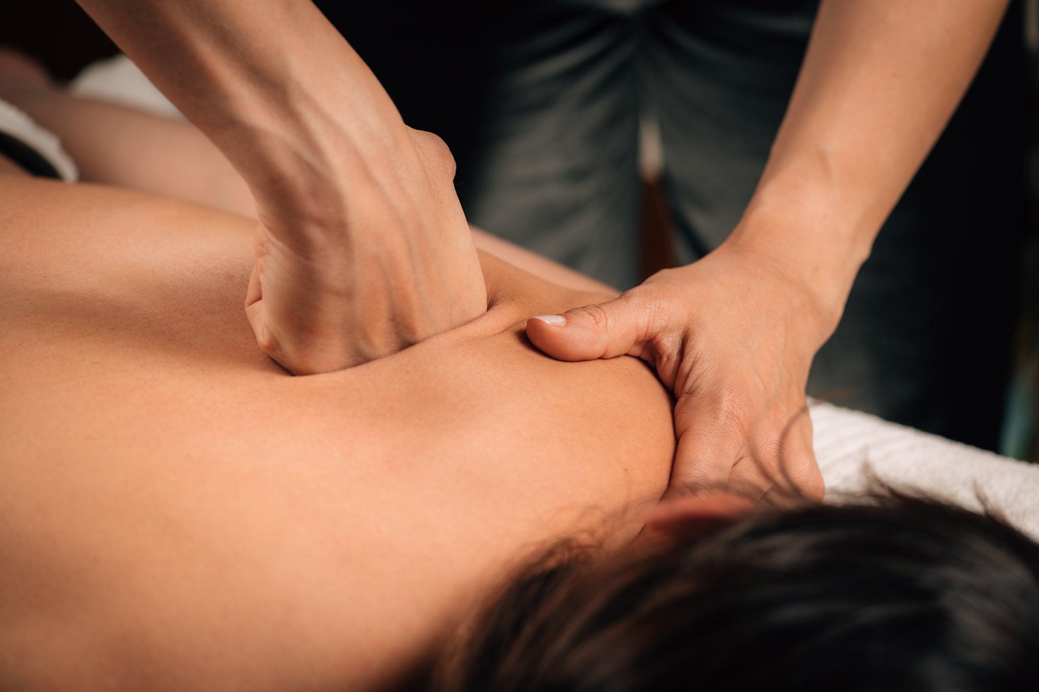 Hands working deep tissue of the back