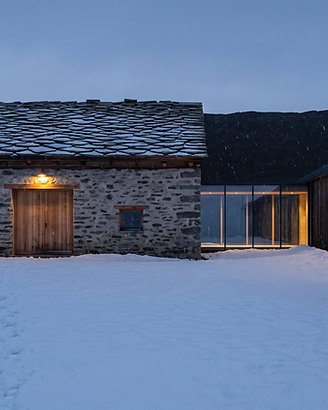 The Barn and the Wing connected by a glass corridor, snow falling