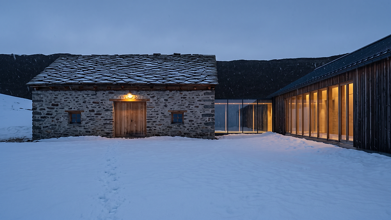 The Barn and the Wing connected by a glass corridor, snow falling