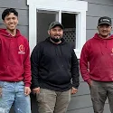 The Cover Compass General Construction team standing outside a project site