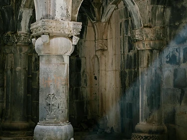 Stone arches opening into a dim, echoing corridor