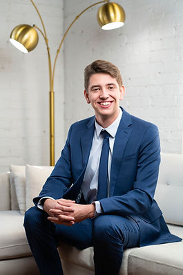 Aiden Beiler, founder of Pillar Cabins, seated in a living room