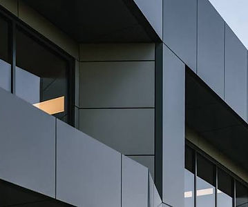Commercial facade clad in angled grey architectural panels