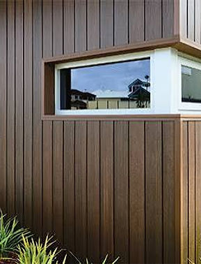 Detail of a dark brown cladding corner with a white-framed corner window