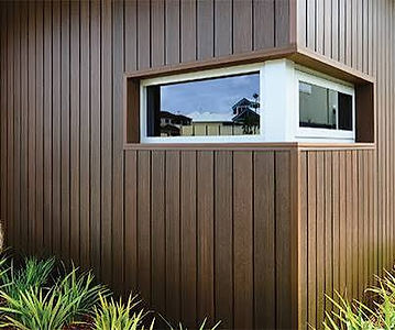 Detail of a dark brown cladding corner with a corner window