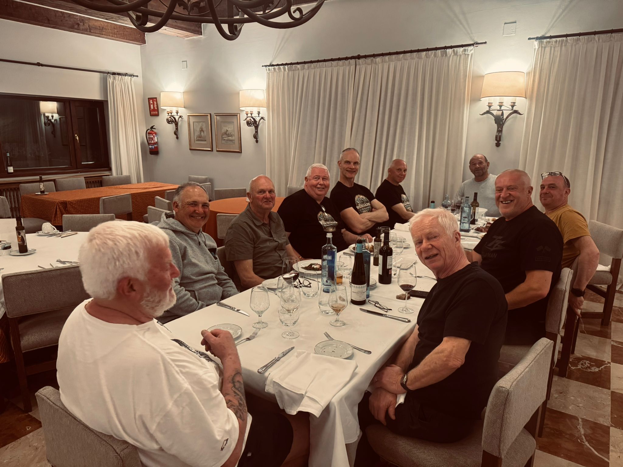 The Wild Roads group around the dinner table at Parador de Fuente Dé — wine, laughter, and a big group dinner