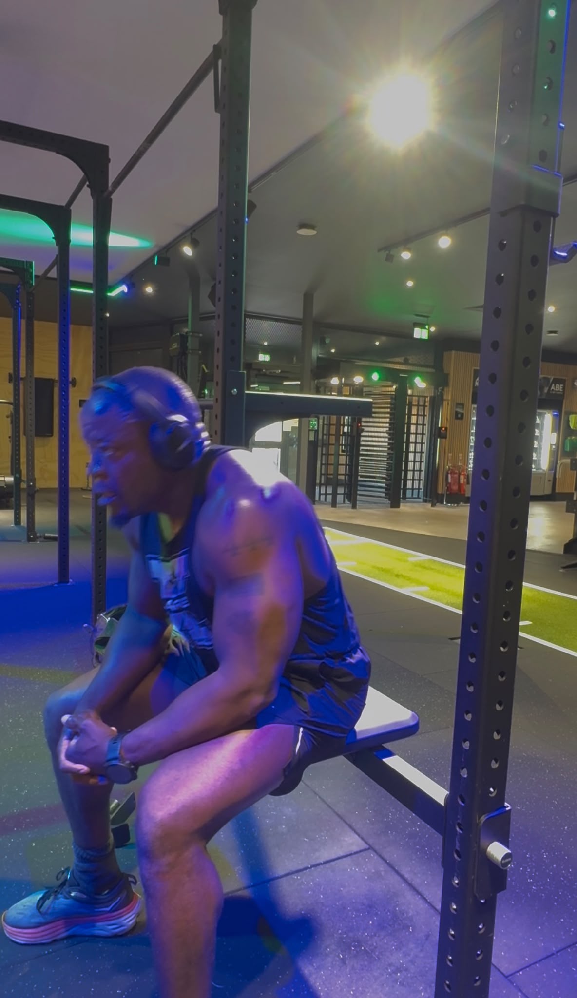 Patrick resting on a gym bench between sets
