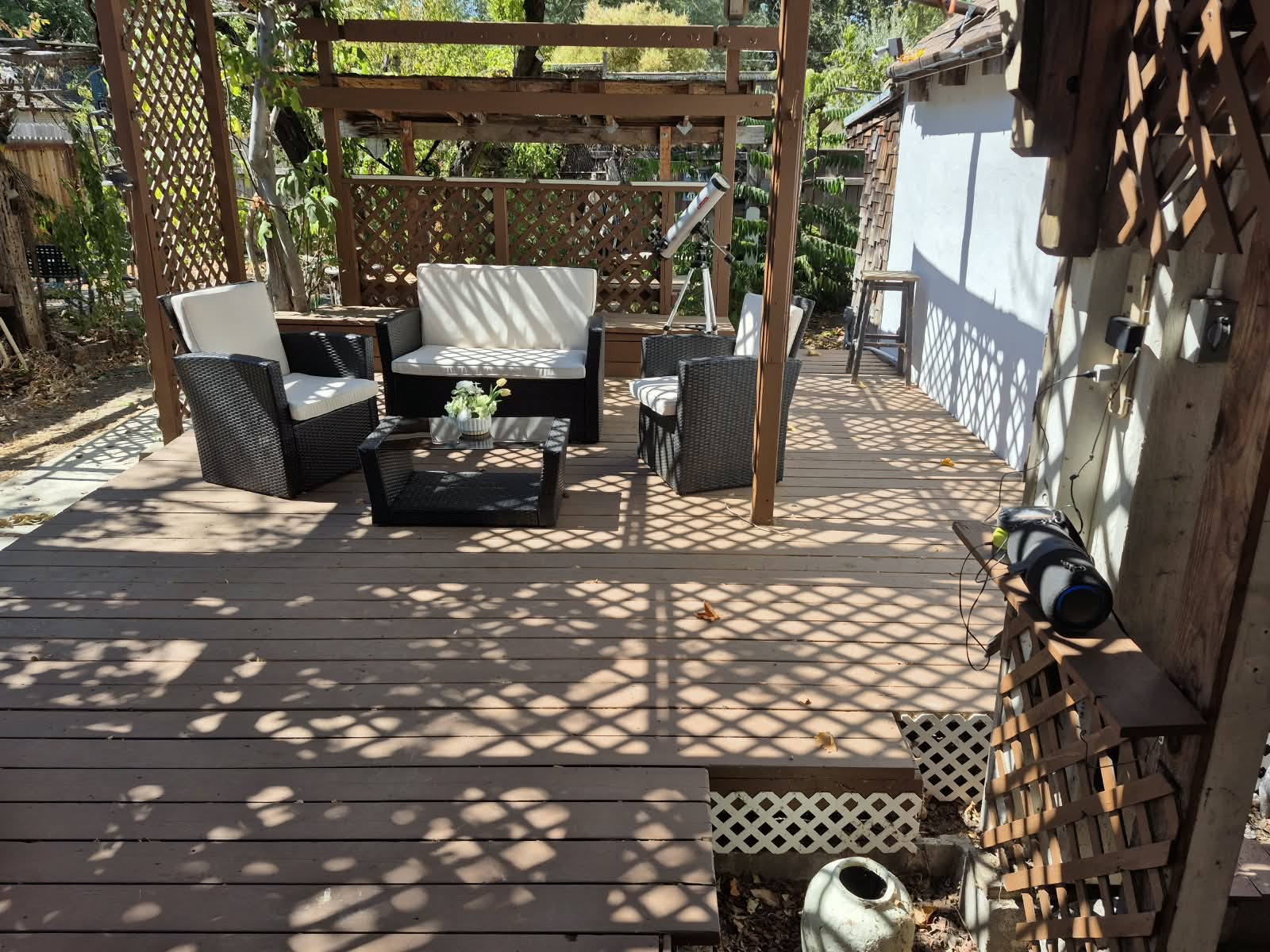 Finished and staged — fully renovated deck under the repaired pergola, move-in-ready outdoor living space.