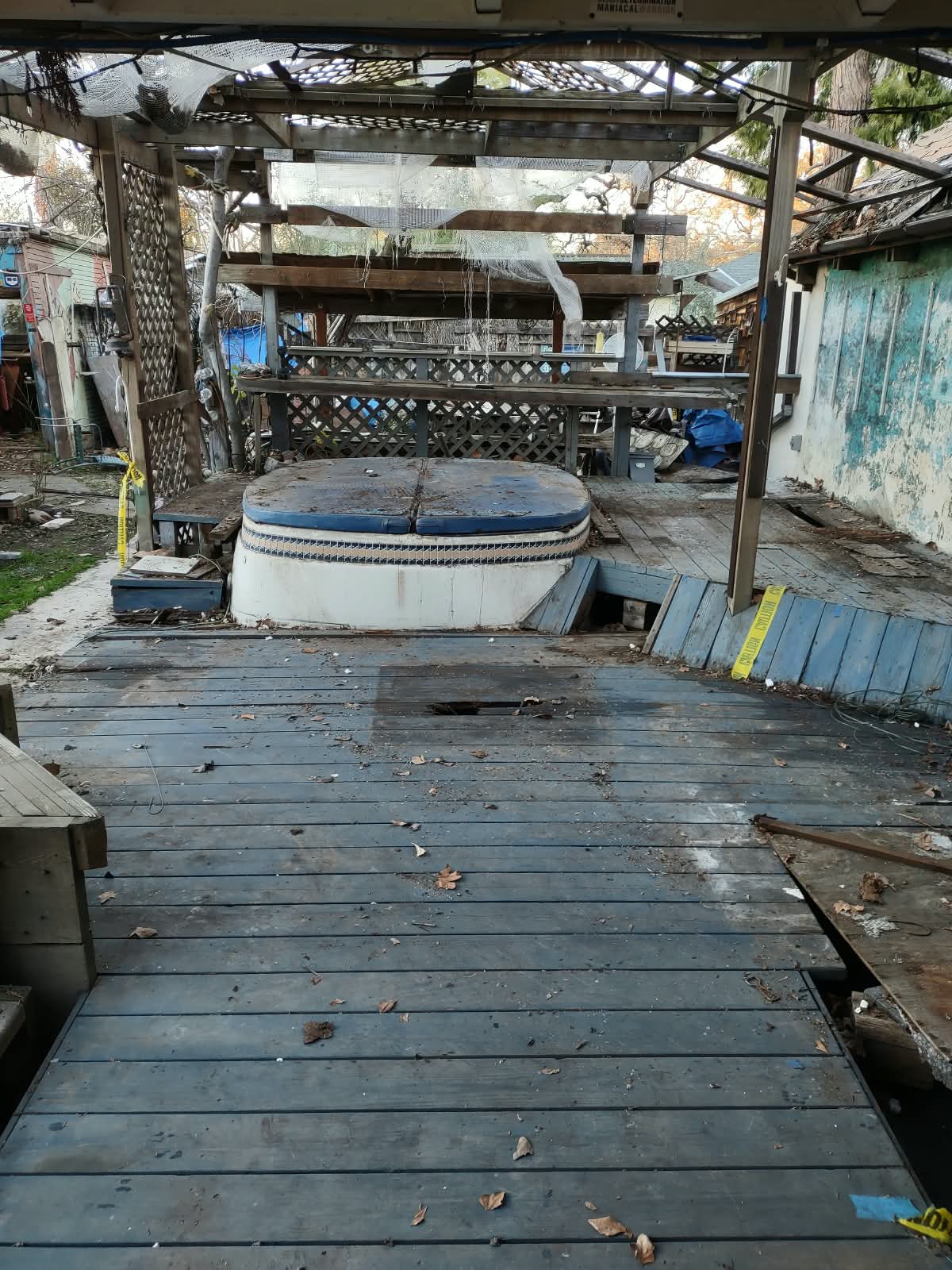 Deteriorated pergola, damaged decking, and disrepair before the porch renovation — the true starting point.